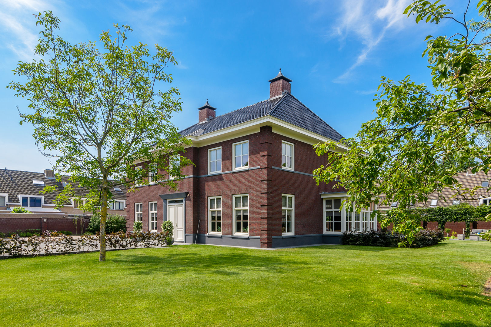 Detached brick home with a well-kept garden