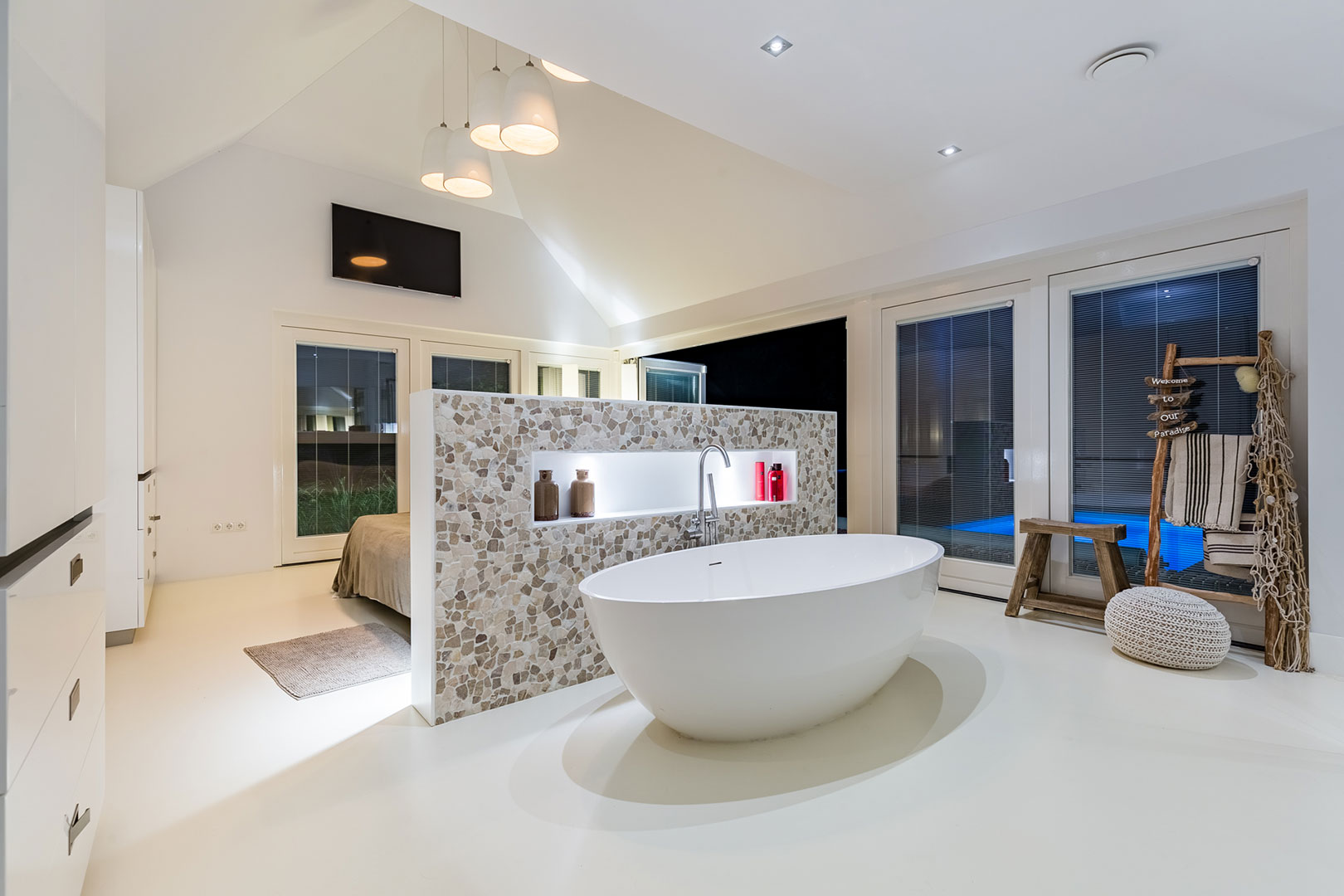 Well-presented bathroom with a freestanding bath and glass shower screen