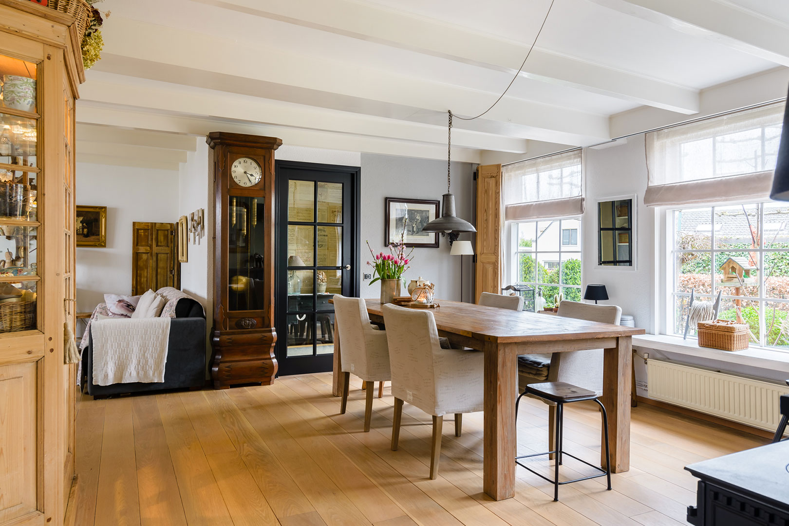 Characterful dining room with a wooden table and large windows
