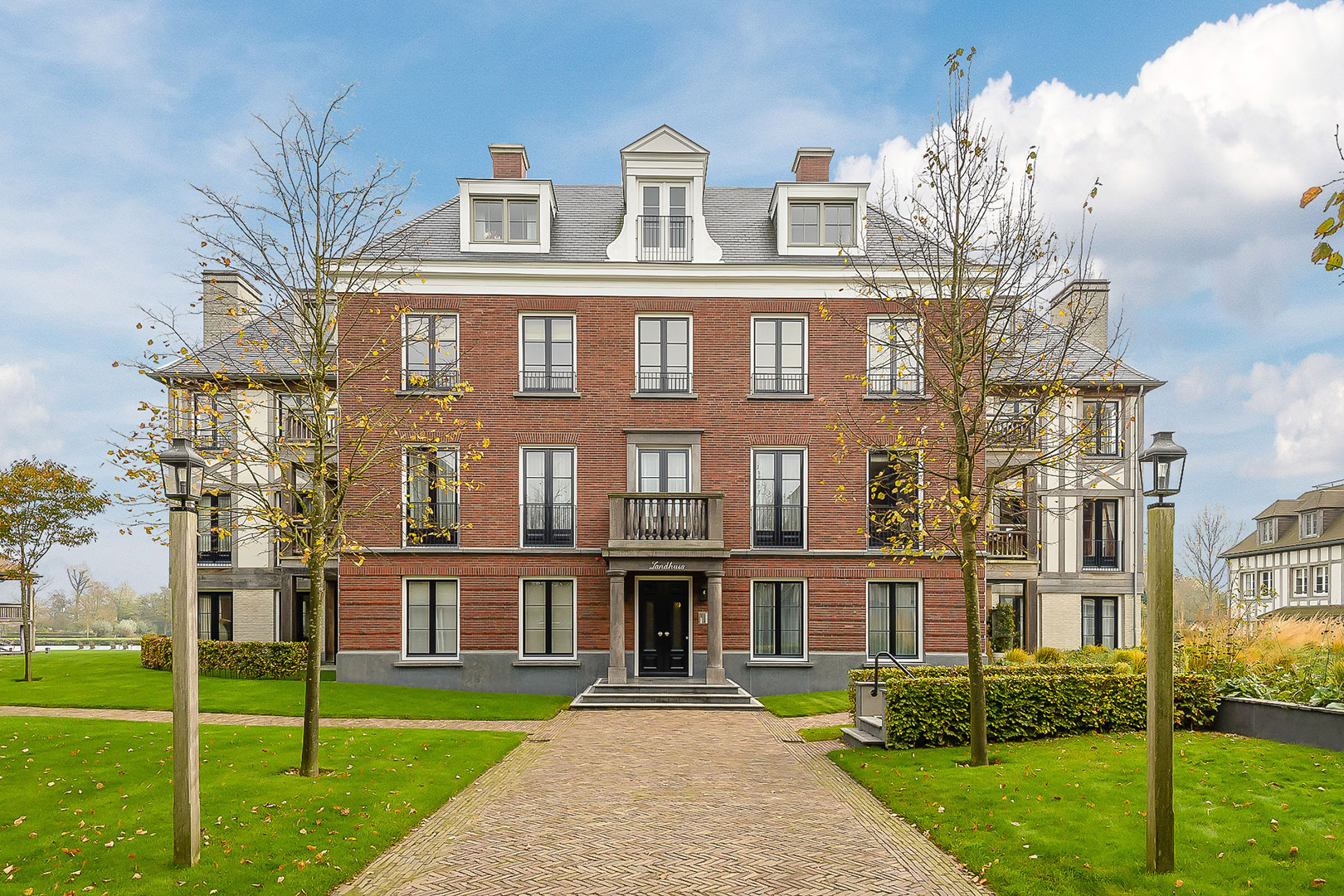 Elegant brick townhouse with a symmetrical front garden
