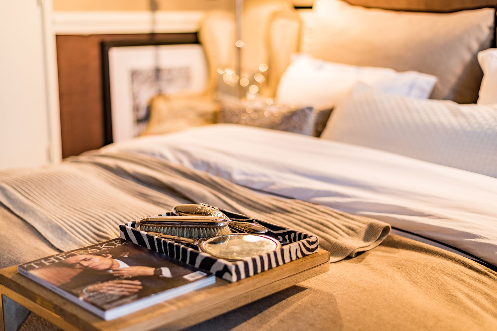 Detail of a made bed in warm evening light