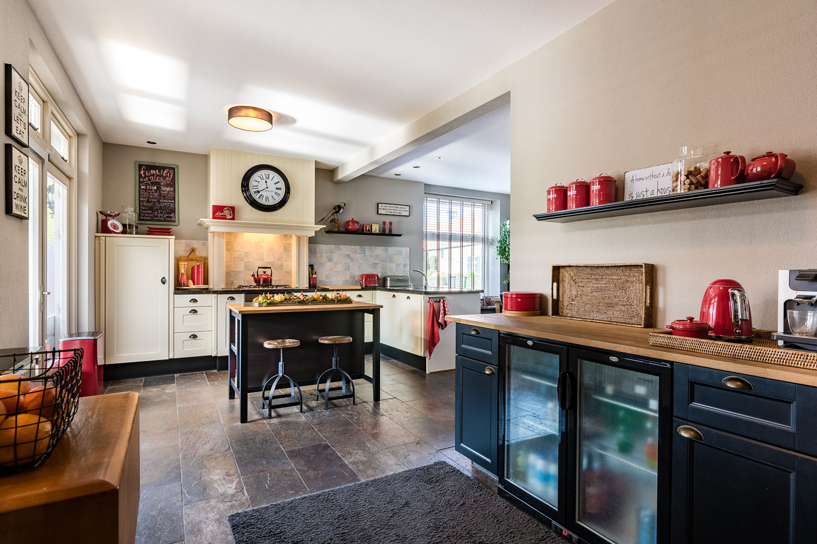 Kitchen-diner with dark flooring and blue kitchen units