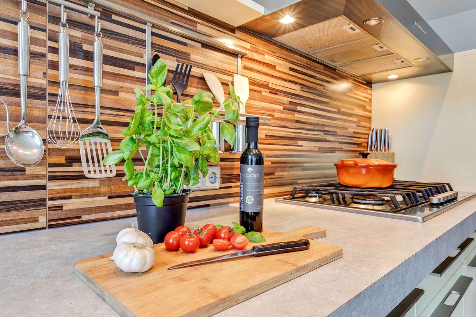 Detail of a kitchen worktop with fresh vegetables and basil